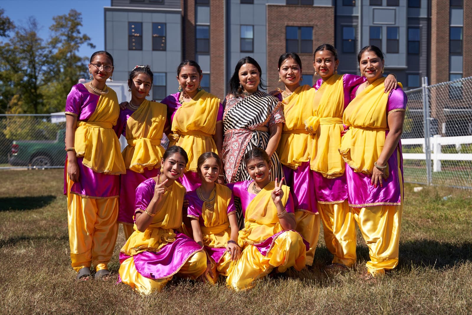 Dancers in yellow and magenta traditional attire